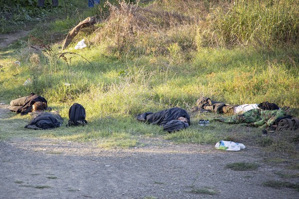Refugees And Migrants At The Greek Borders Refugees and migrants resting, sleeping and praying near, next to river as they are hiding from the authorities. Asylum seekers as seen near Idomeni boreder  ...