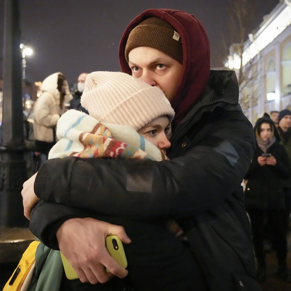 A couple stand and embrace during a gathering in St. Petersburg, Russia, Friday, Feb. 25, 2022. Shocked Russians turned out by the thousands Thursday to decry their country's invasion of Ukraine as em ...