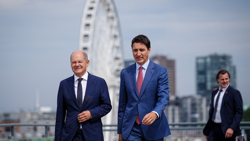 22.08.2022, Kanada, Montreal: Bundeskanzler Olaf Scholz (SPD) und Justin Trudeau (r), Premierminister von Kanada, kommen zur gemeinsamen Pressekonferenz. Im Mittelpunkt der Reise steht die Zusammenarb ...