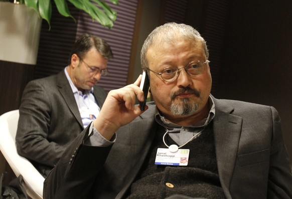 FILE - In this Jan. 29, 2011 file photo, Saudi journalist Jamal Khashoggi speaks on his cellphone at the World Economic Forum in Davos, Switzerland. Khashoggi was a Saudi insider. He rubbed shoulders  ...