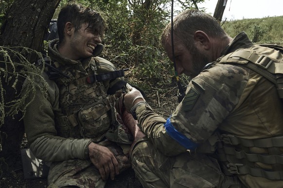 A soldier of Ukraine&#039;s 3rd Separate Assault Brigade gives first aid to his wounded comrade, call sign Polumya (Flame), 19, near Bakhmut, the site of fierce battles with the Russian forces in the  ...