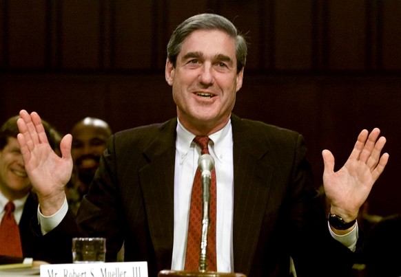 FILE PHOTO: Robert Mueller, as the nominee for FBI director, laughs as Senator Orrin Hatch of the Senate Judiciary Committee asks him how he performed on his lie detector test during a confirmation he ...