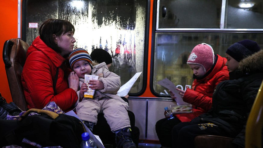 NIZHNY NOVGOROD REGION, RUSSIA - FEBRUARY 22, 2022: People evacuated from Donbass are seen on a bus at a railway station. As tension escalated in east Ukraine on 18 February, 2022, the leaders of the  ...