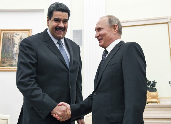 FILE - In this file pool photo taken on Oct. 4, 2017, Russian President Vladimir Putin, right, shakes hands with Venezuela's President Nicolas Maduro during their meeting at the Kremlin in Moscow, Rus ...