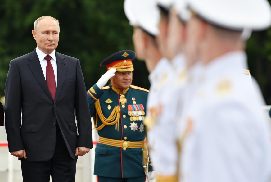 ST PETERSBURG, RUSSIA - JULY 25, 2021: Russia's President Vladimir Putin (L) and Russia's Defense Minister Sergei Shoigu are seen in Senate Square during the main naval parade marking Russian Navy Day ...