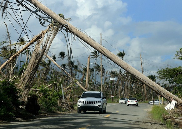 December 3, 2017 - Humacao, PR, USA - A view of electrical poles torn down along roads in Playa Punta Santiago in Humacao, Puerto Rico, that were destroyed by Hurricane Maria, on Dec. 3, 2017. Athlete ...