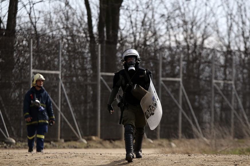 A Greek riot policeman walks near the Kastanies border gate at the Greek-Turkish border, Sunday, March 1, 2020. Thousands migrants massed at the Turkish-Greek border, and hundreds more crossed from th ...