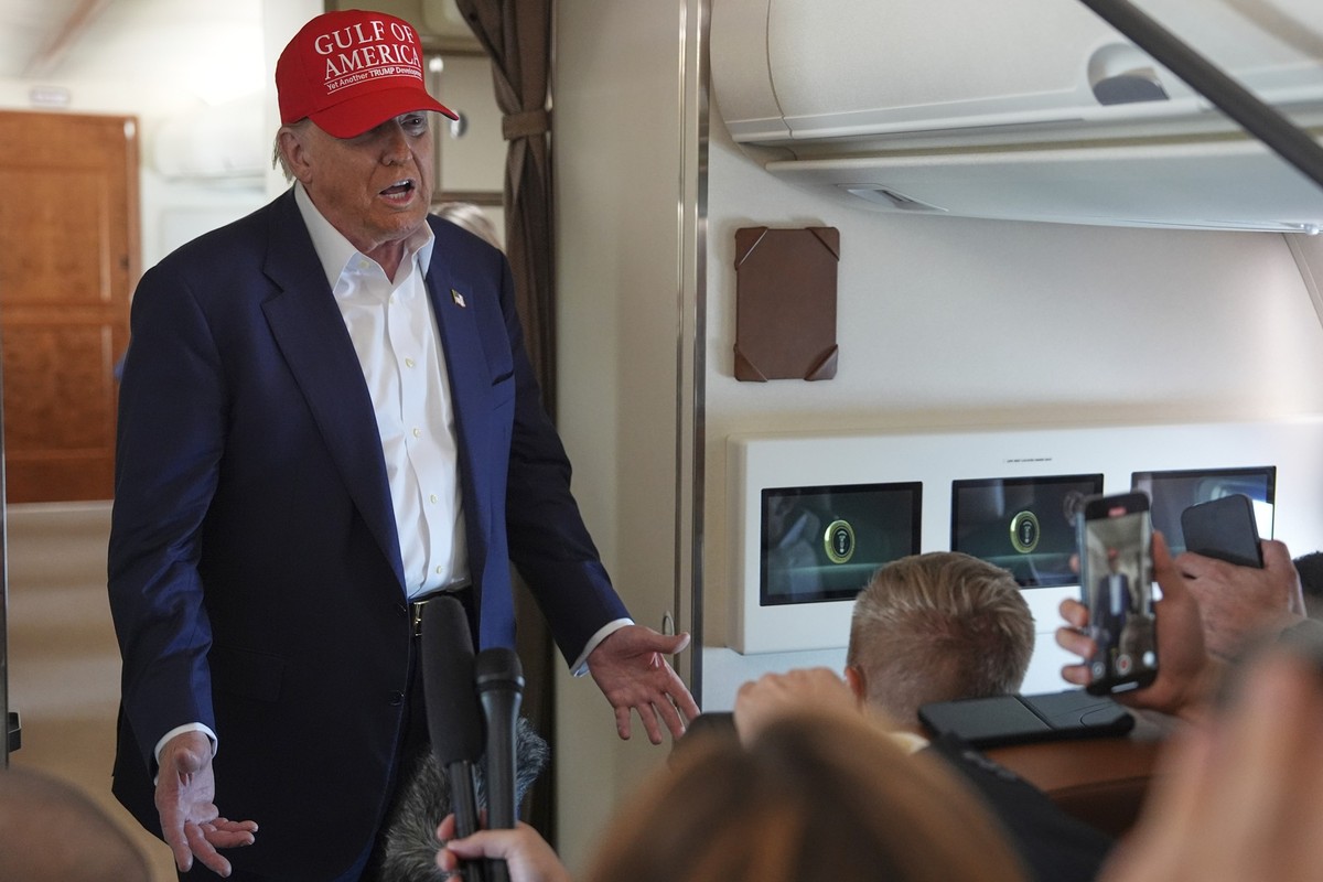 President Donald Trump talks with reporters on Air Force One after visiting a migrant detention center in Ochopee, Fla., Tuesday, July 1, 2025, as he heads back to Joint Base Andrew, Md. (AP Photo/Eva ...