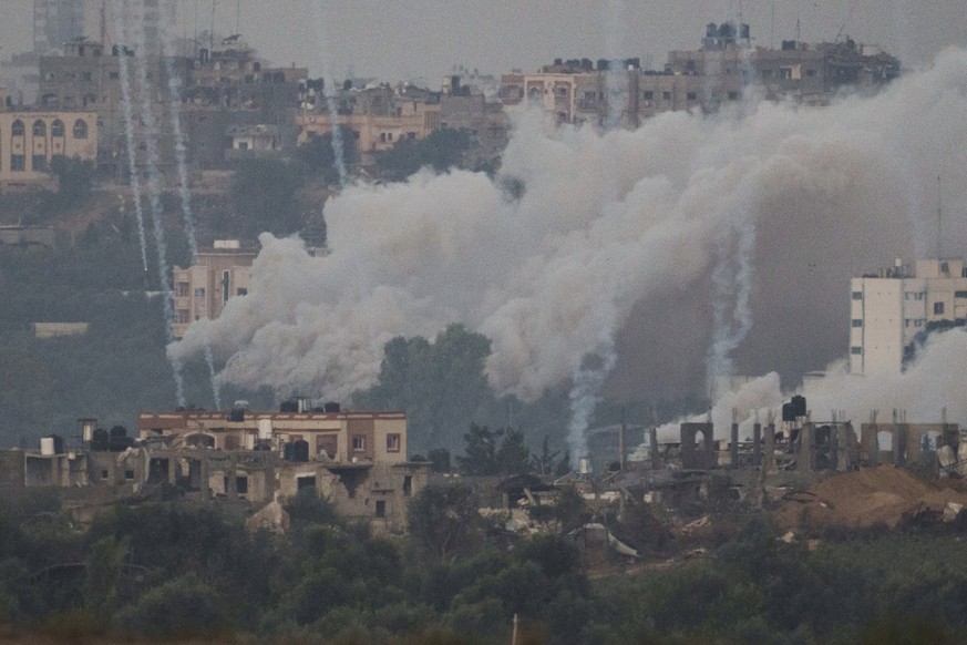 Smoke rises following an Israeli airstrike in the Gaza Strip, as seen from southern Israel, Tuesday, Nov. 21, 2023. (AP Photo/Leo Correa)