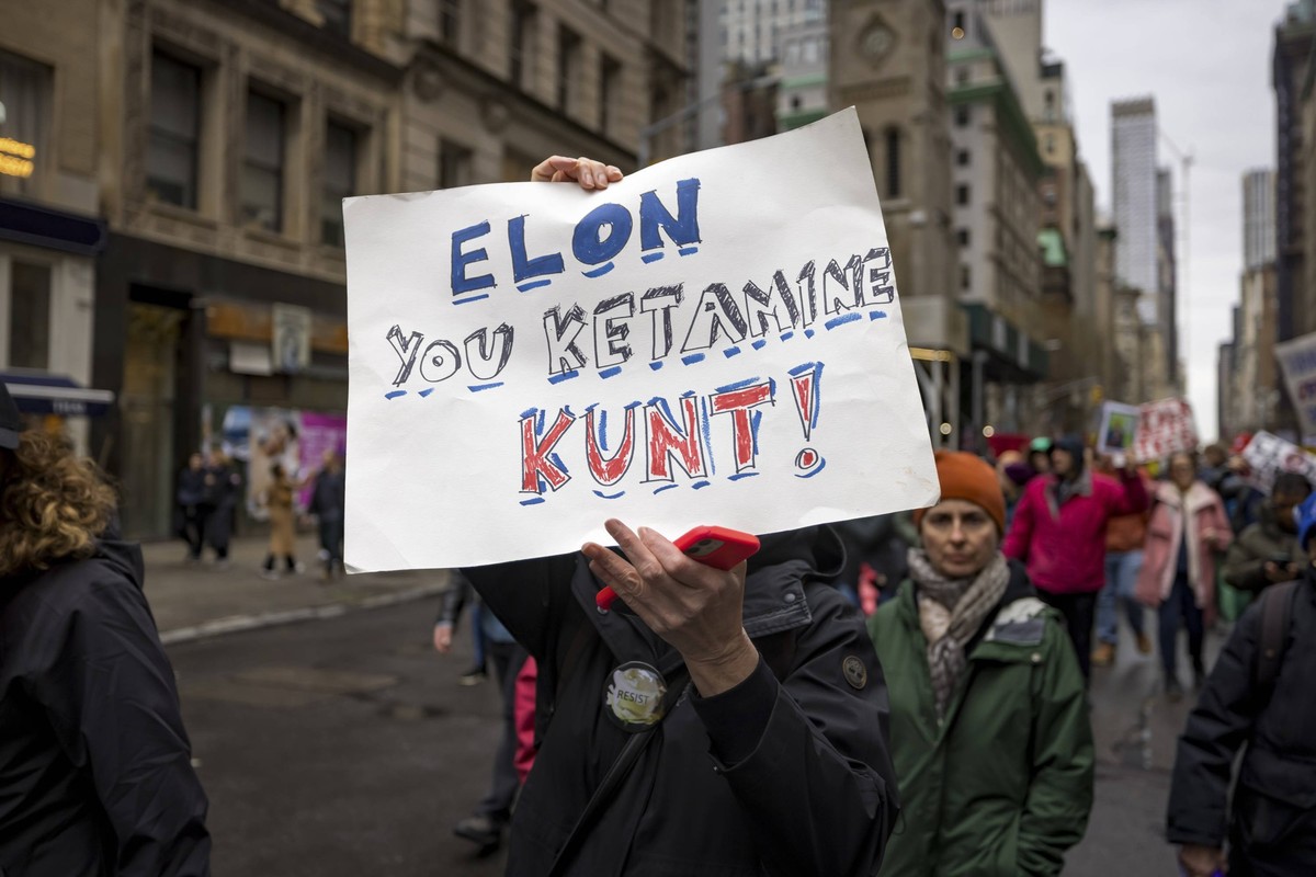 Hands Off protesters rally against Trump in New York A person holds a sign that reads, Elon you ketamine kunt, as tens of thousands of protestors participate in the Hands Off rally, a National Day of  ...