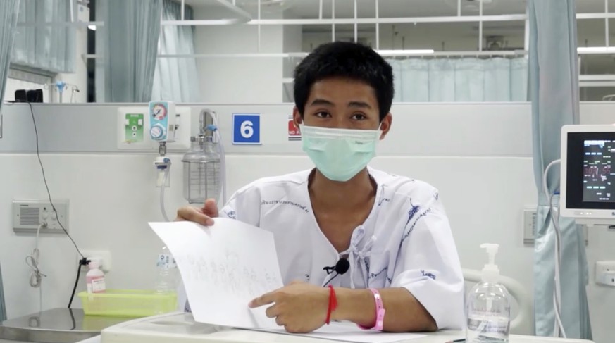 This image made from a video taken on July 13, 2018 and released by Chiang Rai Prachanukroh Hospital, shows Adul Sam-on, one of the 12 boys rescued from the flooded cave, in their hospital room at Chi ...