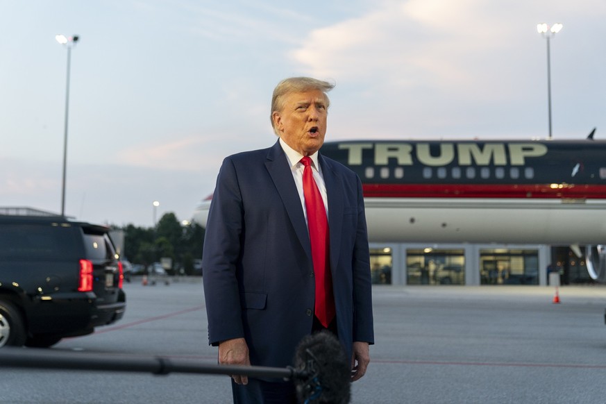 Former President Donald Trump speaks with reporters before departure from Hartsfield-Jackson Atlanta International Airport, Thursday, Aug. 24, 2023, in Atlanta. (AP Photo/Alex Brandon)