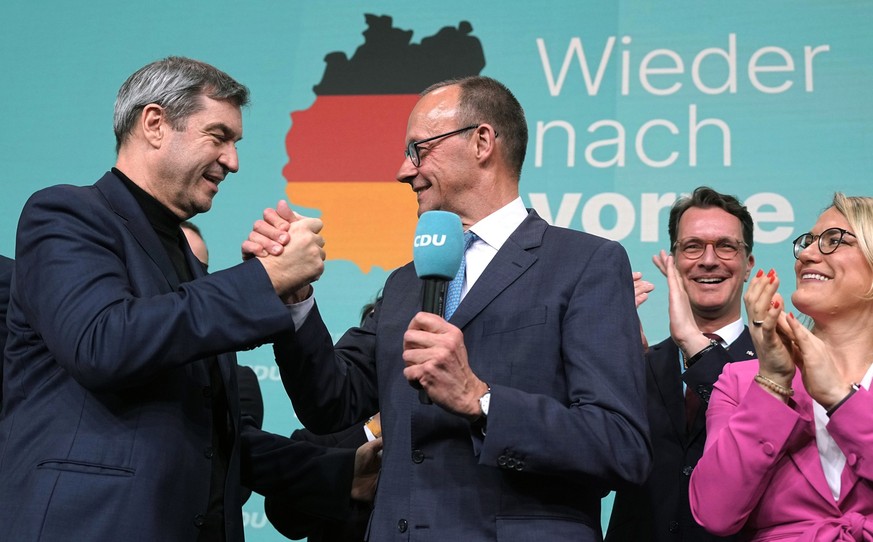 23.02.2025, Berlin: Friedrich Merz (CDU, M), Parteivorsitzender und Kanzlerkandidat, steht zwischen Markus Söder (l), Ministerpräsident von Bayern und CSU-Vorsitzender, und Christina Stumpp, stellvert ...