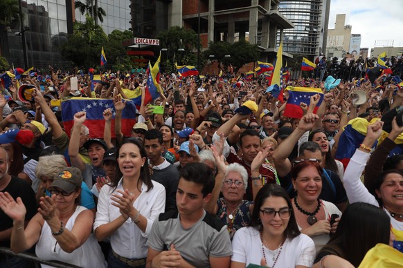 Citizens raise their hands during the speech of President of the Venezuelan National Assembly Juan Guaido as he declares himself interim president of the country, in Caracas, Venezuela, 23 January 201 ...