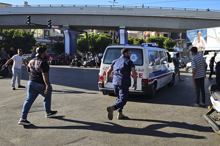 An ambulance carries wounded people whose handheld pager exploded, in Beirut, Lebanon, Tuesday, Sept. 17, 2024. (AP Photo/Hassan Ammar)