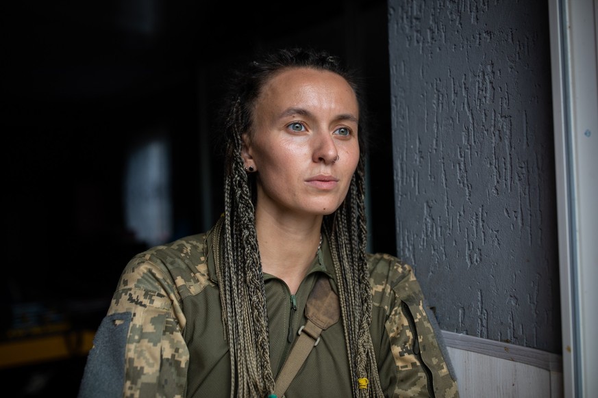 Combat medic Yara Chornohuz stands in the doorway of her reconnaissance unit’s base in eastern Ukraine.