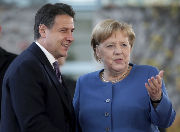 FILE - In this Tuesday, Nov. 19, 2019 file photo, German Chancellor Angela Merkel, right, and Italy&#039;s Prime Minister Giuseppe Conte, left, shake hands prior to a meeting at the chancellery as par ...